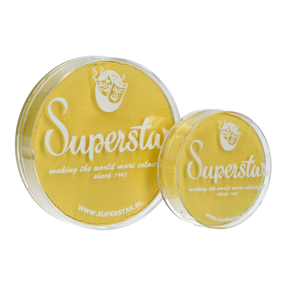Two circular containers of Infinity Faces Face Paint & Body Paint Aqua Superstar - Soft yellow (16gr) are cruelty-free and adhere to European Cosmetics Legislation. The larger container displays the slogan making the world more colorful since 1947 plus a website link.