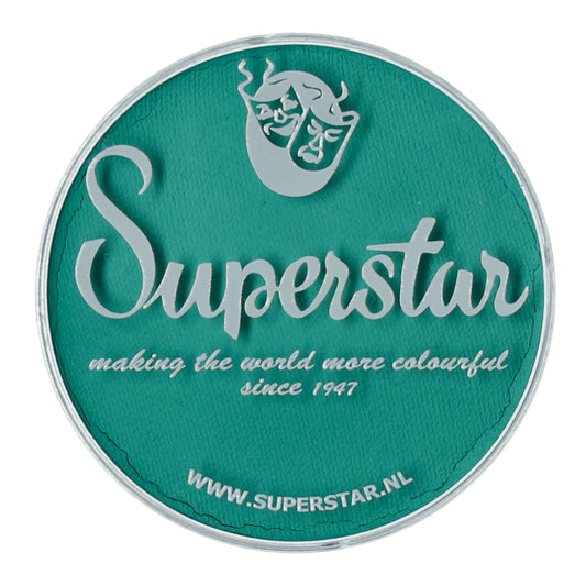 The teal circular logo showcases Superstar in large cursive with an abstract face above and making the world more colourful since 1947 below, celebrating their cruelty-free ethos. Visit WWW.SUPERSTAR.NL for Infinity Faces renowned water-based Face Paint & Body Paint Aqua Superstar - Teal (45gr).