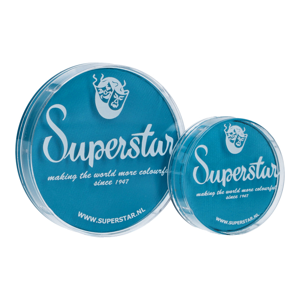 Two blue containers branded with Infinity Faces in white text, each showing a stylized mask logo on their lids. The larger container contains cruelty-free Face Paint & Body Paint Aqua Superstar - Magic Blue (45gr) with making the world more colourful since 1947 and the URL www.superstar.nl below.