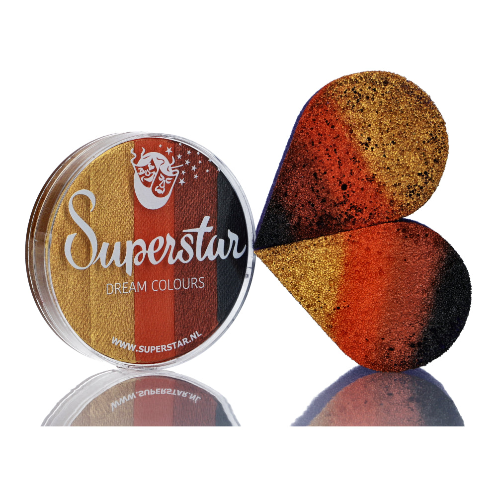 A round Split Cake Dream Colour Superstar - Safari (45gr) by Infinityfaces sits beside a teardrop sponge. Its vibrant orange, red, and black gradient hues shine brilliantly on the white surface, highlighting its water-based finish.