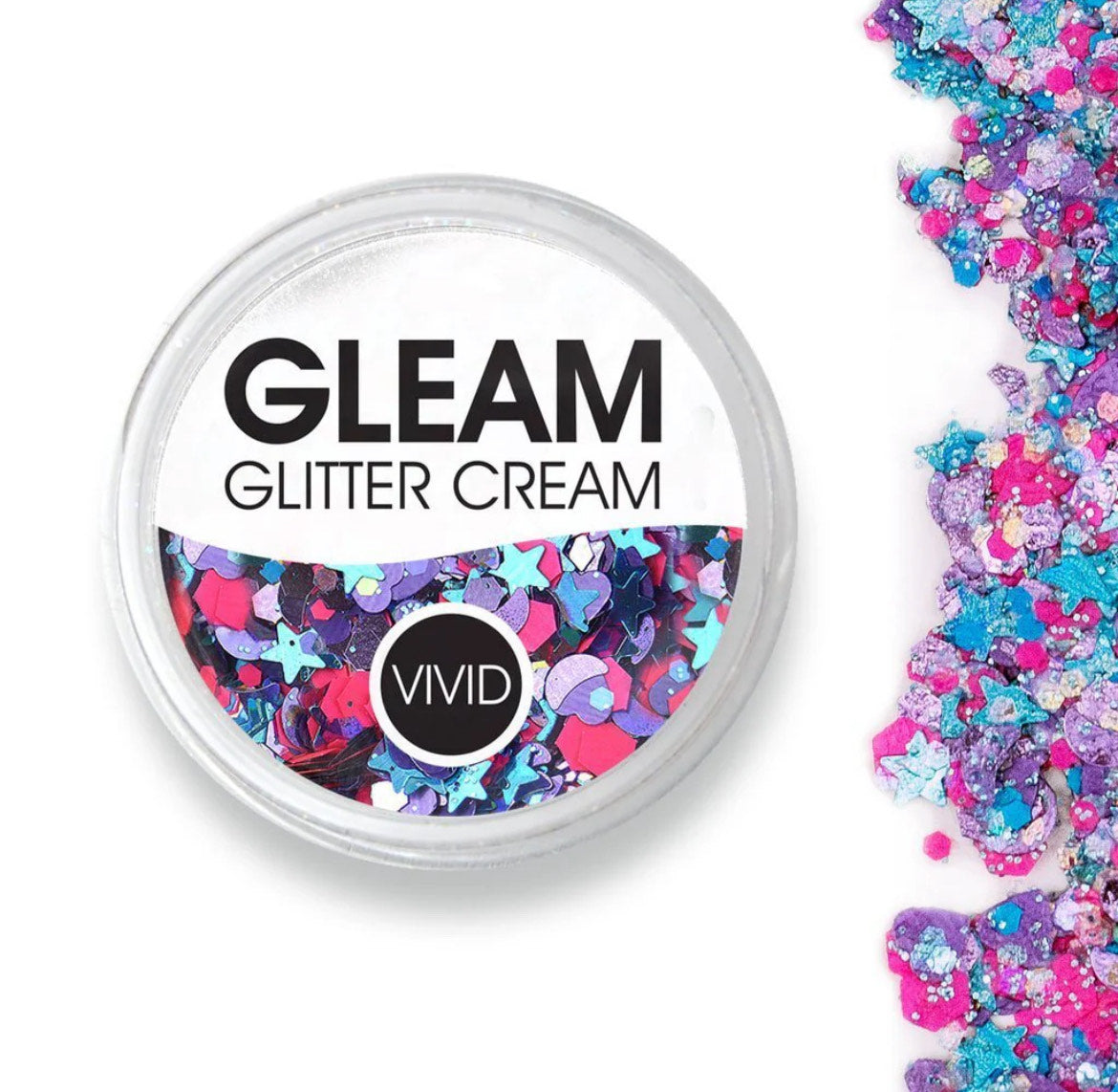 A round Infinity Faces Glitter Cream Gleam - Blazin Unicorn (10g) container holds chunky pink, blue, and purple glitter cream, with matching glitter scattered beside it on a white surface.