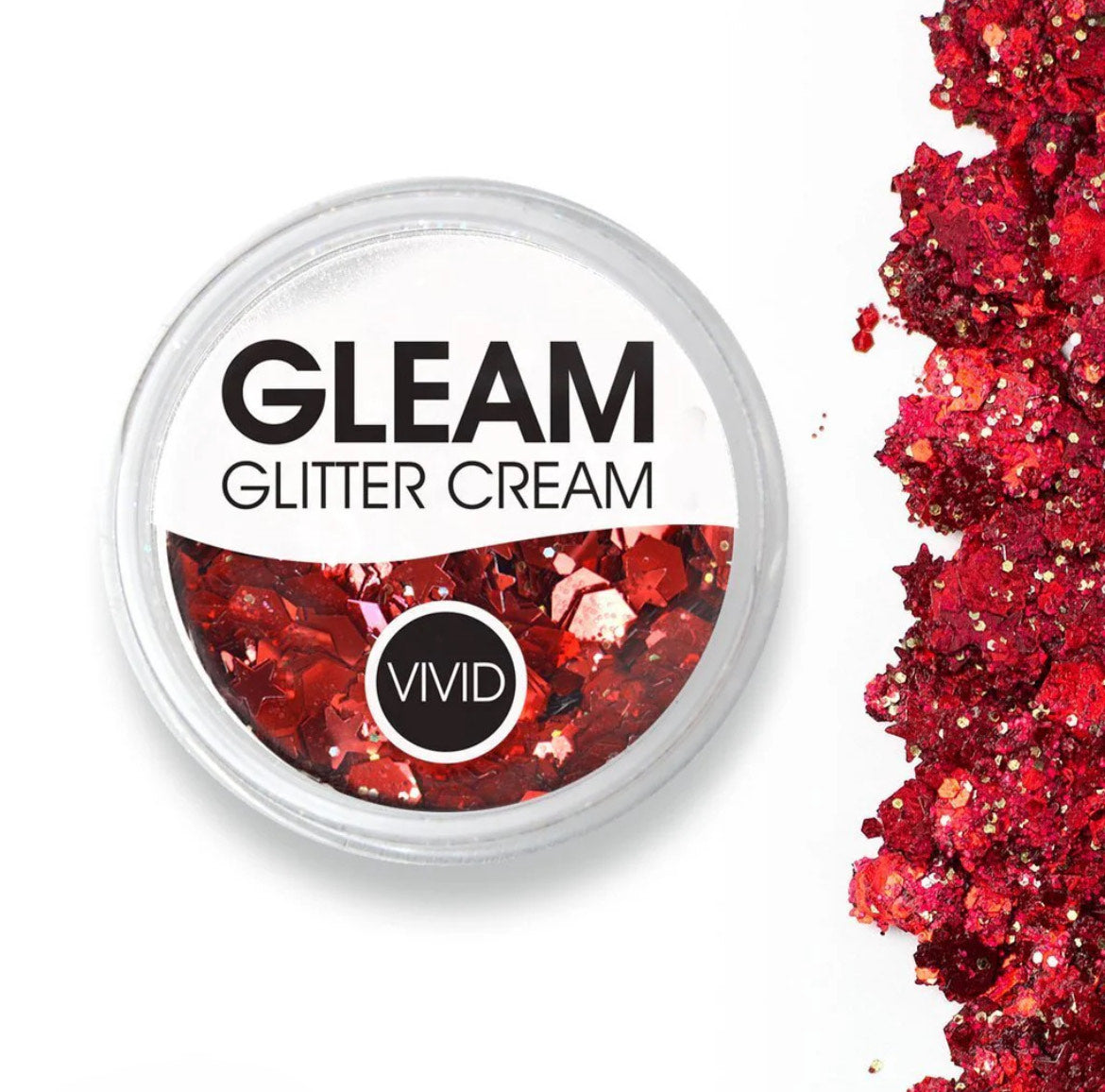 A round Infinity Faces Glitter Cream Gleam - Cardinal red (10g) container filled with chunky red glitter rests on a white background, with red glitter piles scattered along the right edge.