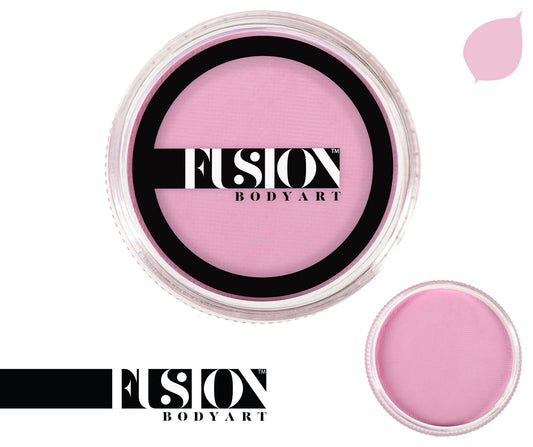 A round container of Infinity Faces aqua Fusion face and body paint in Pastel Pink (25g) features a clear lid with the brand logo. A smaller, open view of the paint appears at the bottom right, while a pink leaf-shaped design is in the top right corner.