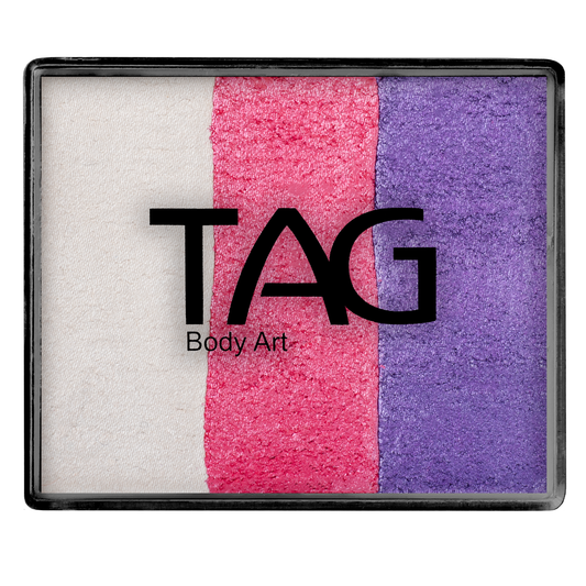 The Face Paint & Body Paint Aqua - Pearl Dream Base Blender Split Cake (50g) by Infinityfaces features a rectangular palette with three vertical stripes—white, pink, and purple—and the bold black TAG Body Art logo across the colors.