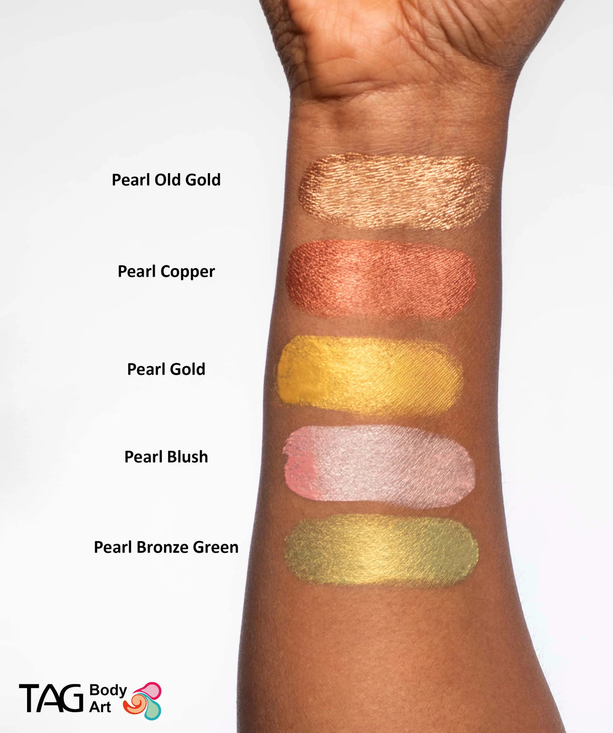 Five swatches of TAG Face & Body Paint - Pearl Bronze Green (32g) and four other colors in bronze, copper, gold, and light pink applied to a forearm, labeled with their respective names.