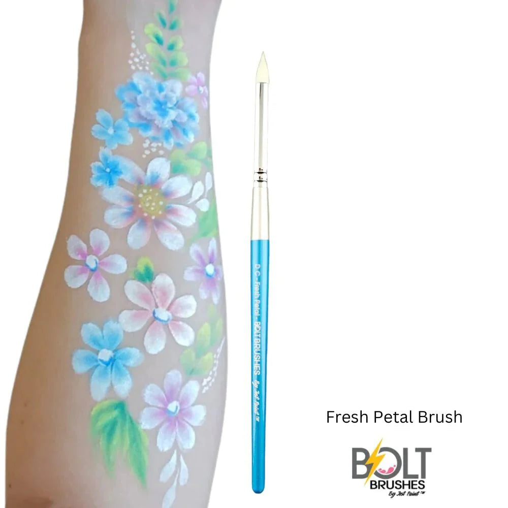 A blue-handled paintbrush appears beside an arm adorned with colorful floral designs. The text reads Infinity Faces Brushes Bolt - Diamond Collection - Fresh Petal, with a stylized yellow lightning bolt.