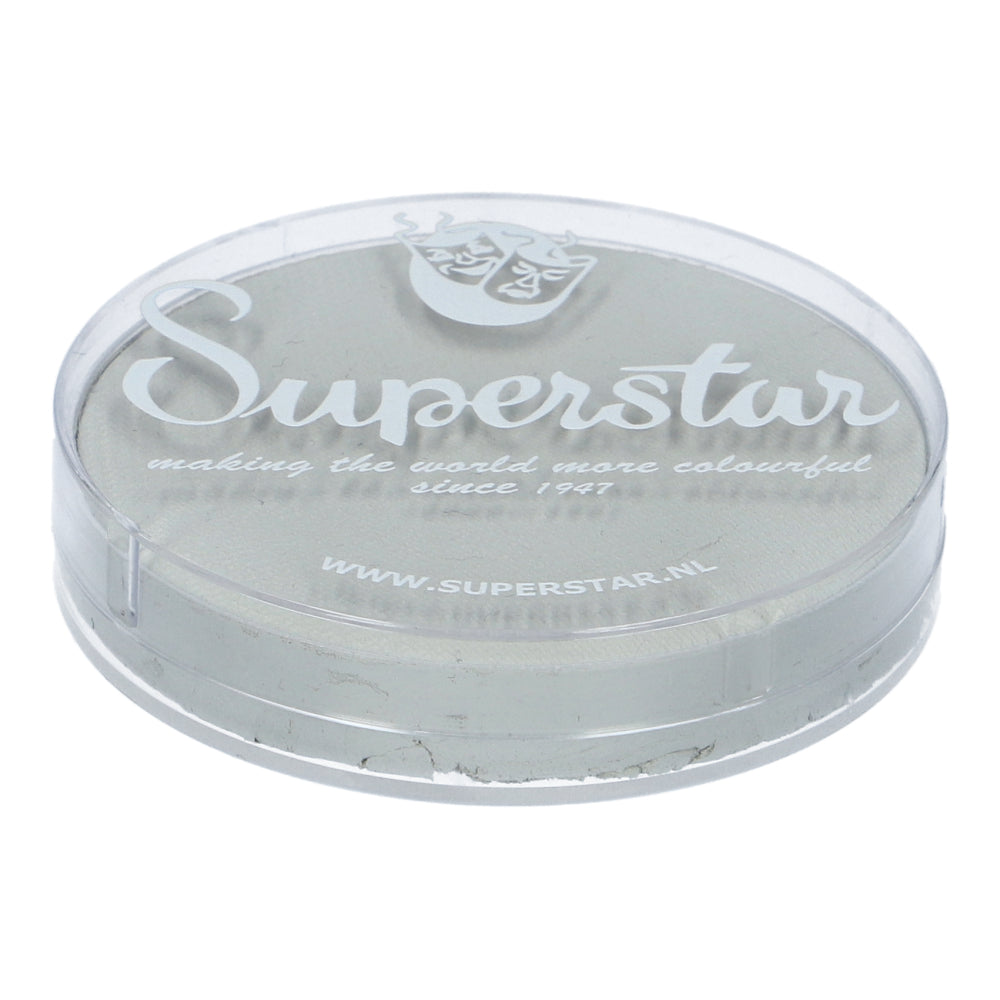 A round, transparent Infinity Faces container labeled Face Paint & Body Paint Aqua Superstar - Skull (16gr) features a light-colored, cruelty-free makeup product. It includes a website link and the text: making the world more colourful since 1947, aligning with European Cosmetics Legislation.
