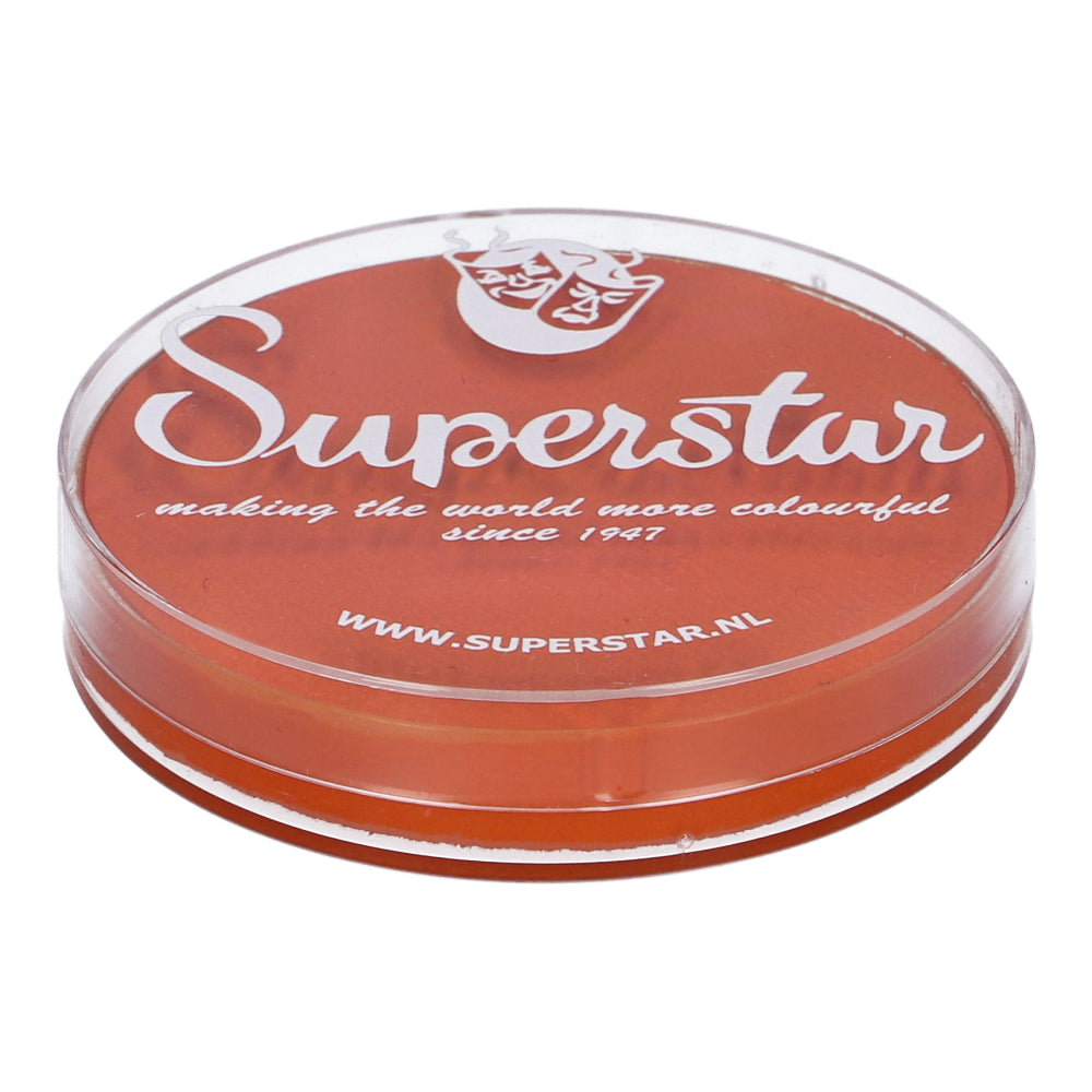 A round, transparent container displays the Dark Orange Face Paint & Body Paint Aqua Superstar (16gr) by Infinity Faces. With a theatrical mask logo and Superstar text on the lid, it emphasizes its cruelty-free, water-based formula with the tagline making the world more colorful since 1947.