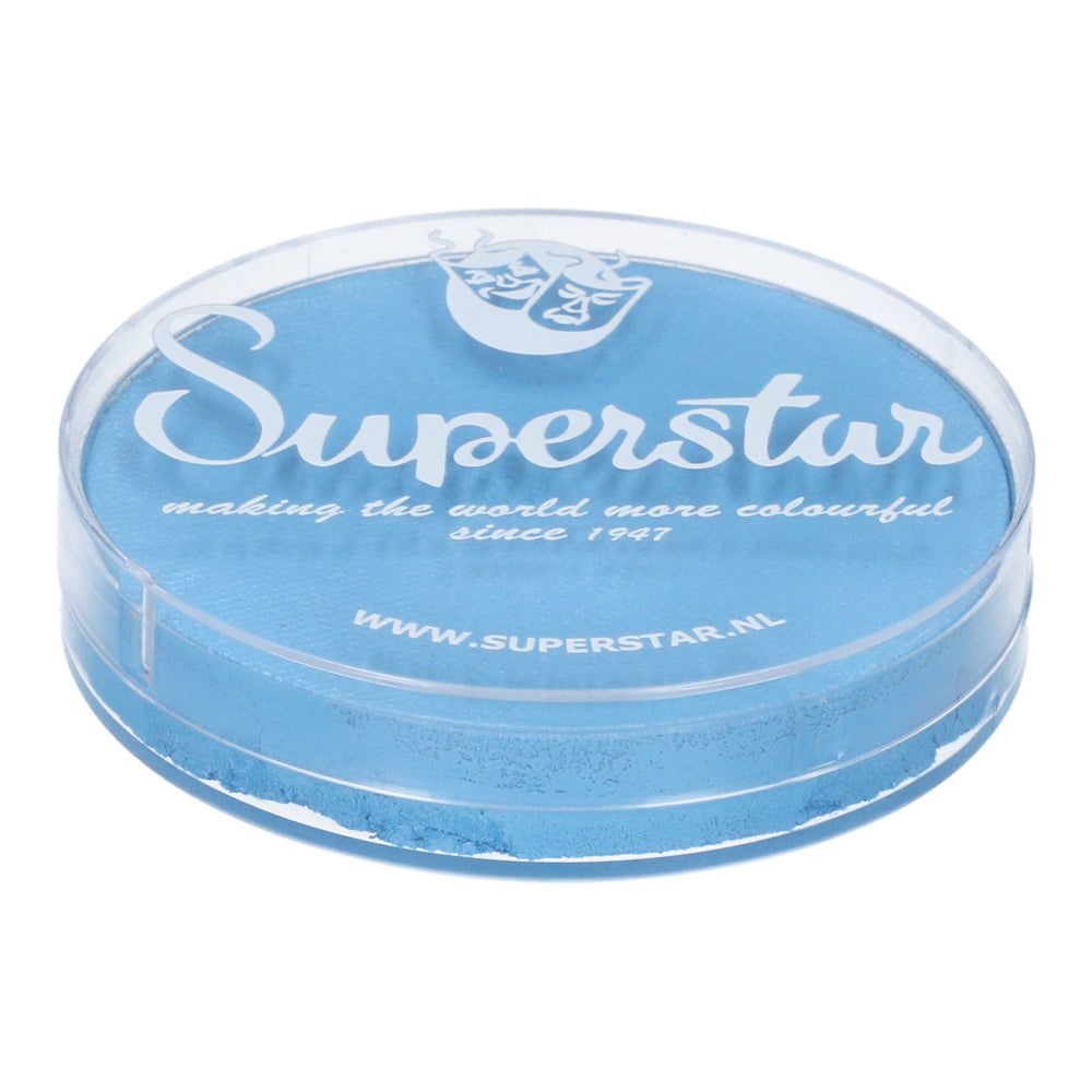 A round, transparent plastic container holds 45g of shimmer Baby Blue Face & Body Paint Aqua by Infinity Faces. The lid features white text: Superstar, making the world more colourful since 1947, and www.superstar.nl. This cruelty-free, water-based makeup suits all your creative needs.