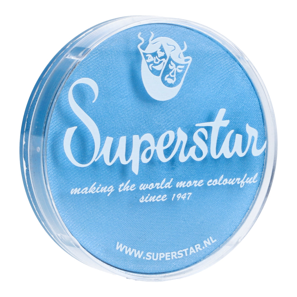 A round container of baby blue shimmer makeup by Infinity Faces features white text reading Superstar with a theater mask logo, stating making the world more colourful since 1947. It highlights its cruelty-free ethos and includes the website www.superstar.nl.