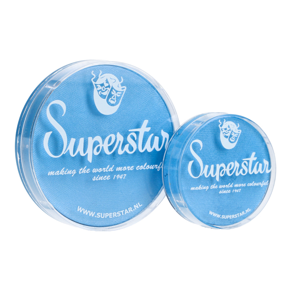 Two round containers of Face Paint & Body Paint Aqua Superstar in Baby blue shimmer (45gr) from Infinity Faces feature white Superstar branding. The larger container states making the world more colorful since 1947 with a face logo, showcasing their cruelty-free, water-based makeup. URLs are at the bottom.