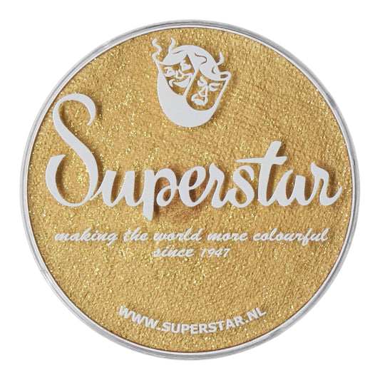 Gold glitter makeup container labeled Superstar by Infinity Faces, featuring a face logo and the tagline making the world more colourful since 1947. It includes the website www.superstar.nl and complies with EU Cosmetics Legislation 1223/2009/EC for water-based makeup.