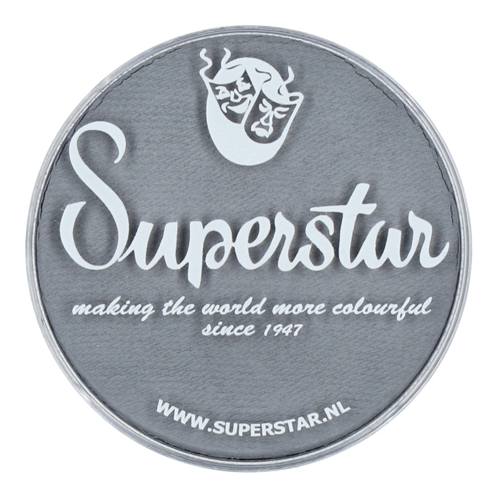 A circular gray patch features Superstar in white cursive. Above it, a flaming mask adds flair, and below it reads making the world more colourful since 1947 with WWW.SUPERSTAR.NL, showcasing Infinity Faces Aqua Superstar Face & Body Paint—light grey, water-based makeup safe for children.