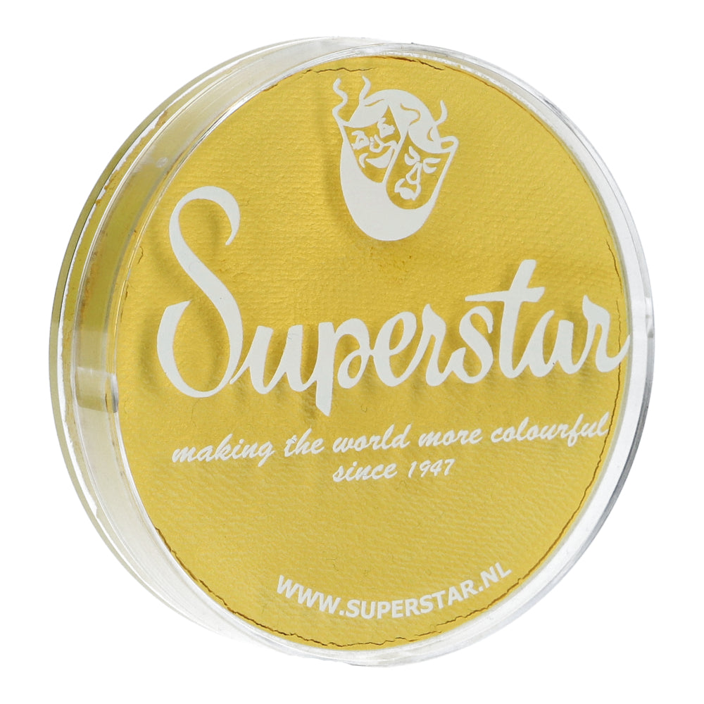 The small round container features a yellow lid with Superstar in white script. Below it are the phrases making the world more colourful since 1947 and WWW.SUPERSTAR.NL. A theater mask icon indicates compliance with European Cosmetics Legislation standards. Product: Face Paint & Body Paint Aqua Superstar by Infinity Faces.