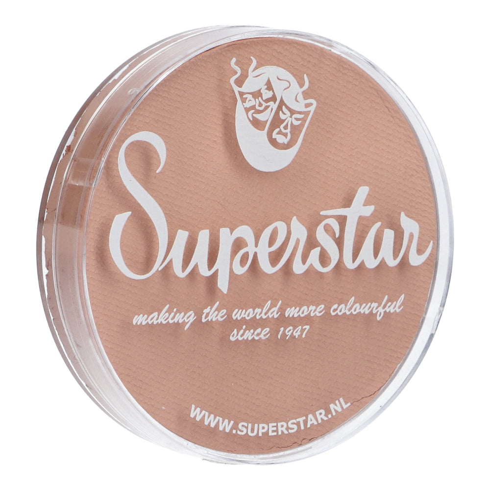 A round container with a transparent lid displays light brown contents labeled Infinity Faces in white text. Below, it reads making the world more colourful since 1947, with a theatrical mask logo. Visit www.superstar.nl for cruelty-free Face & Body Paint Aqua Superstar by Infinity Faces, water-based and ideal for Santa Claus skin complexion (16g).