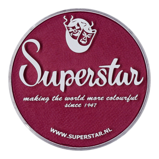 Circular logo with purple background, white text Superstar, and making the world more colourful since 1947. Features a white mask design promoting the child-friendly Infinity Faces Face & Body Paint Aqua Superstar - Majestic Magenta (45gr). Visit: www.superstar.nl.