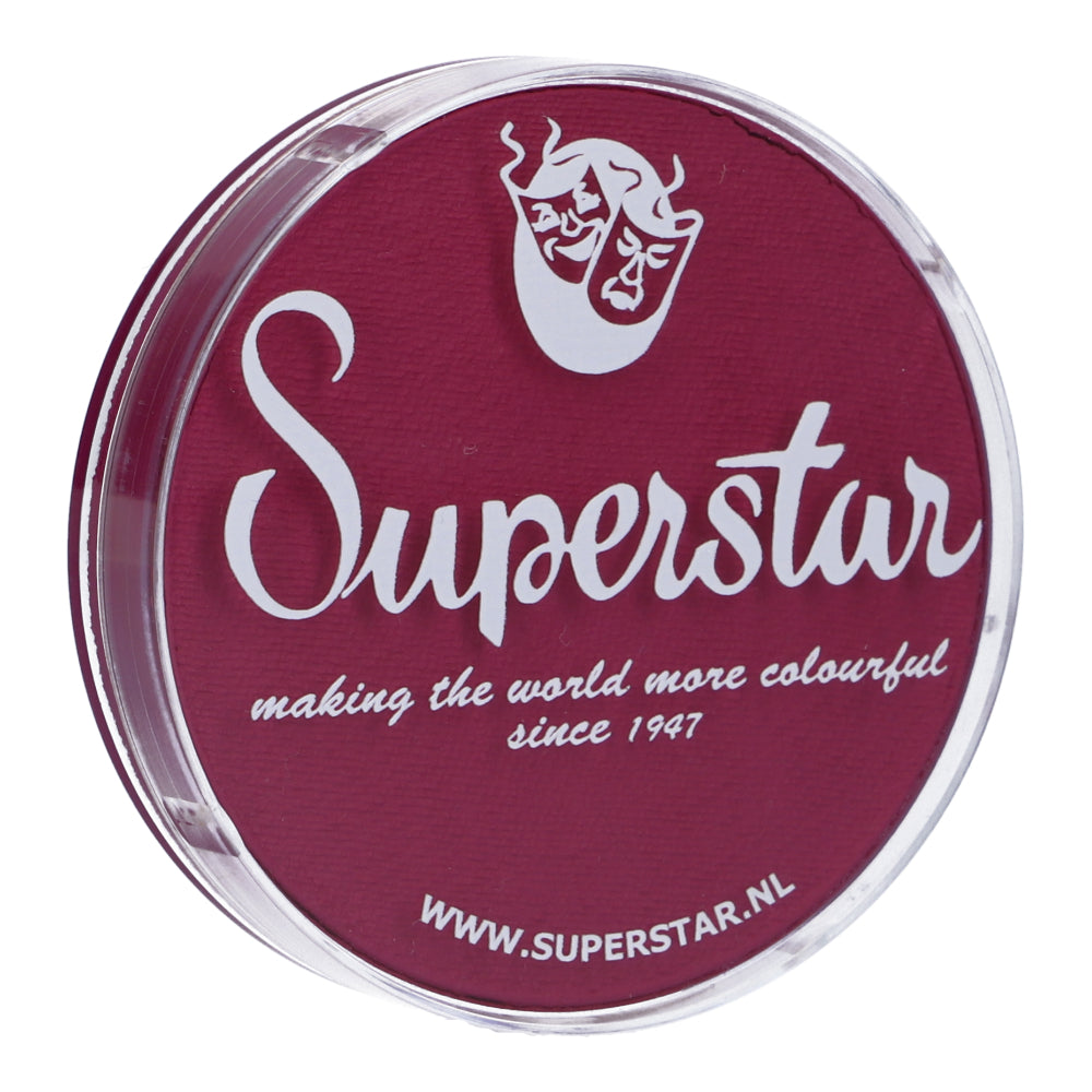 Round red container labeled Infinity Faces with theatrical mask logo, ideal for kids. Text reads, making the world more colourful since 1947. Discover our Majestic Magenta Face & Body Paint Aqua (45g), water-based and available at www.superstar.nl.