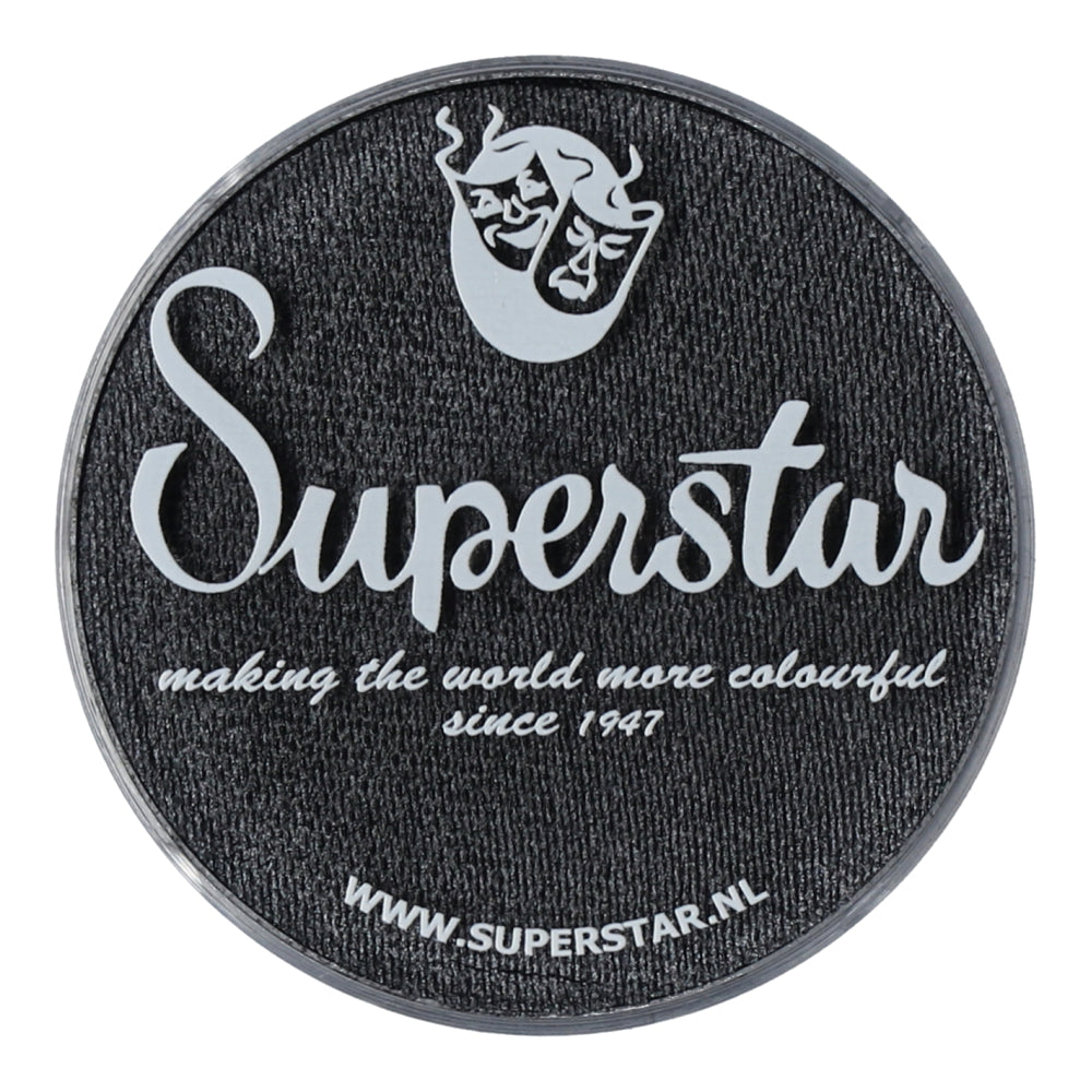 A circular black patch with white cursive Superstar below a mask logo reads, Making the world colorful since 1947 with Aqua Face & Body Paint, featuring Infinity Faces cruelty-free water-based makeup. Visit www.superstar.nl for their Graphite (shimmer) product.