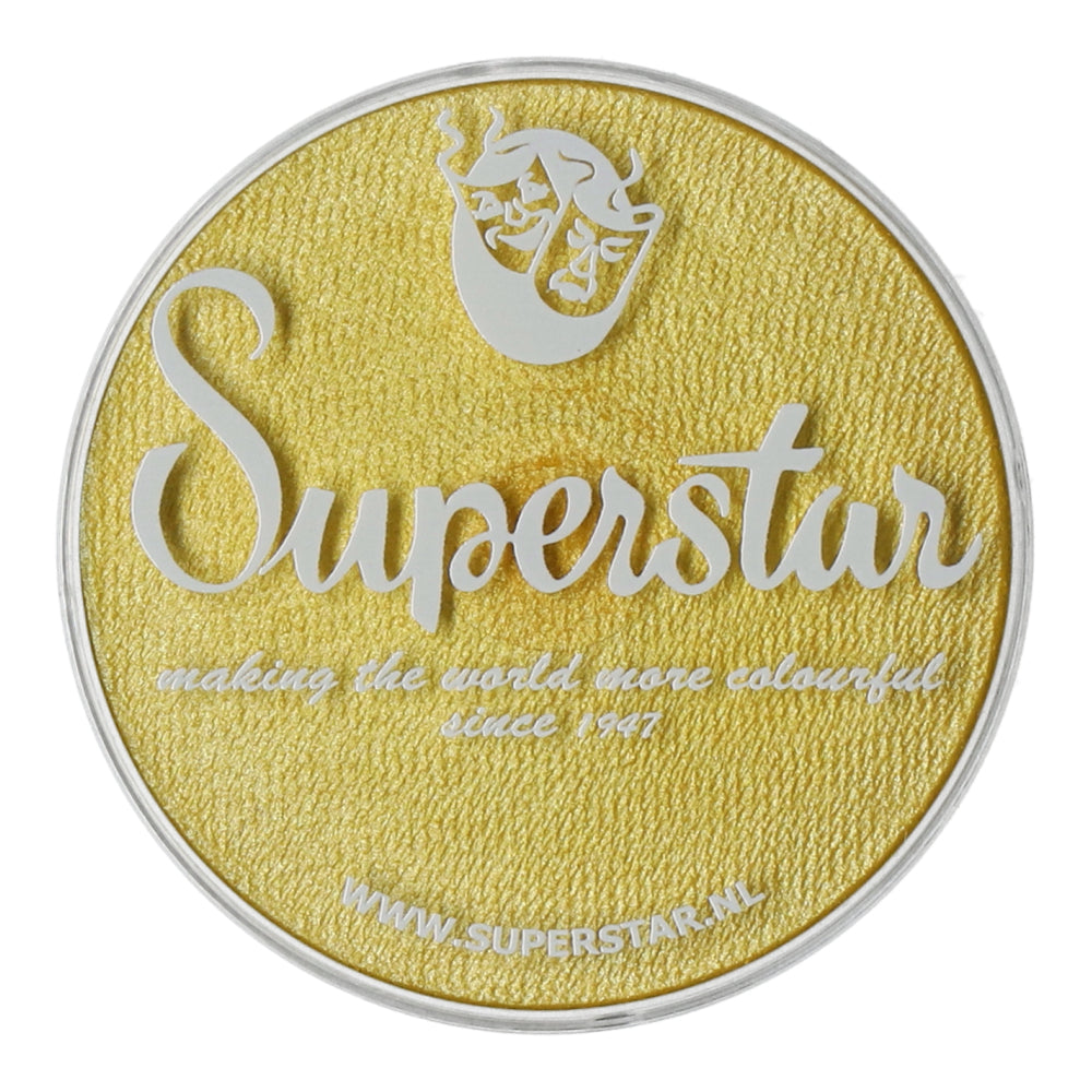 The round, yellow textured container lid features a white cursive Superstar text. It includes the phrase making the world more colourful since 1947, and a logo with a stylized figure at the top. For cruelty-free Aqua Face & Body Paint by Infinity Faces, visit WWW.SUPERSTAR.NL.