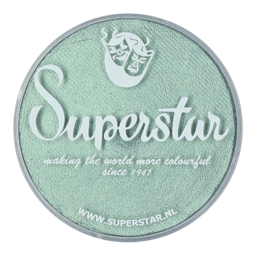 Round container of mint green makeup featuring the Infinity Faces logo with making the world more colourful since 1947 in white font. A stylized mask sits above, showcasing Face Paint & Body Paint Aqua Superstar - Seashell Shimmers vibrant colors. Visit www.superstar.nl for this water-based beauty.