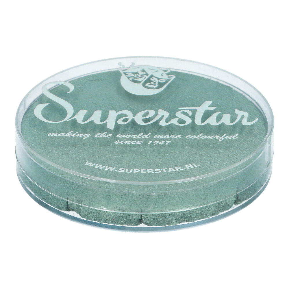 A clear round container from Infinity Faces labeled Superstar contains vibrant green Face & Body Paint Aqua Superstar - Seashell Shimmer (45g), showcasing its textured surface. The text reads: making the world more colorful since 1947, with a website URL for this water-based makeup.