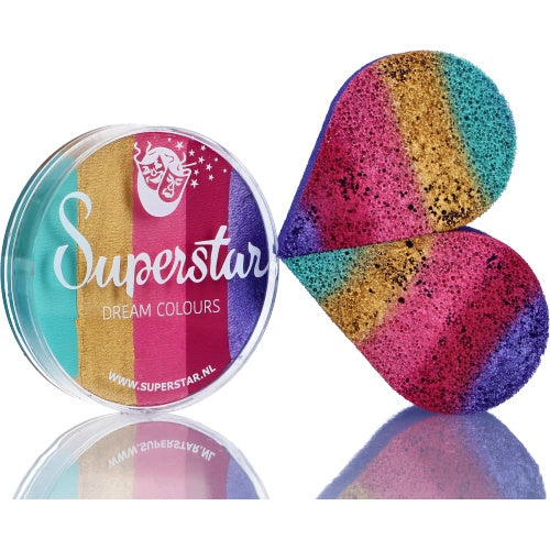 The Infinityfaces Split Cake Dream Colour Superstar - Candy (45gr) sits beside a rainbow-striped makeup sponge, showcasing vibrant teal, gold, pink, and purple water-based face paints ideal for creative looks.