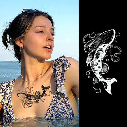 A person with short brown hair swims in a blue patterned swimsuit, showcasing Infinityfaces Temporary Herbal Tattoo - a Magical Whale on their chest. Crafted with plant-based ink, this skin-safe design is also displayed separately against a black background, with the ocean visible in the distance.