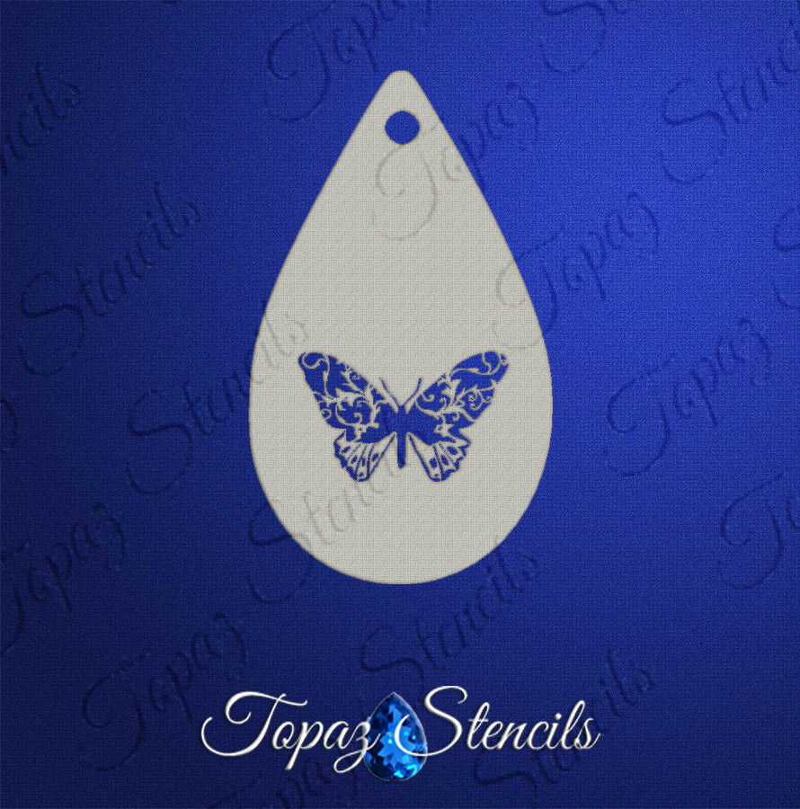 The Infinityfaces Face- & Body Stencil - Butterfly Swirl - Topaz features a teardrop-shaped butterfly design with intricate patterns, ideal for stamping or airbrushing, shown on a blue background labeled “Topaz Stencils.”.