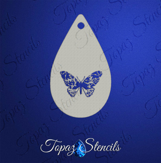 The Infinityfaces Face- & Body Stencil - Butterfly Swirl - Topaz features a teardrop-shaped butterfly design with intricate patterns, ideal for stamping or airbrushing, shown on a blue background labeled “Topaz Stencils.”.