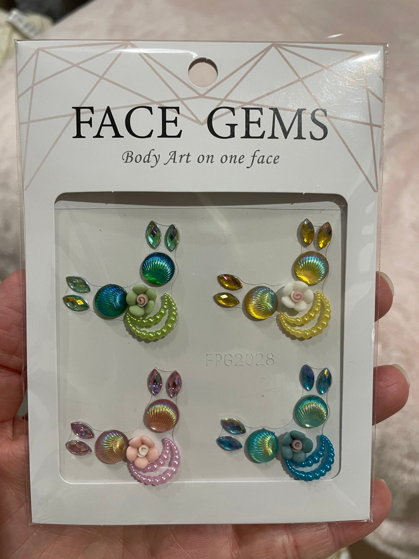 The Face- & Body Gems - Flower Beads by Infinityfaces are colorful crystal and bead clusters designed for facial decoration. Each floral design includes four teardrop-shaped accents and can be easily applied using the included adhesive for a secure all-day fit.