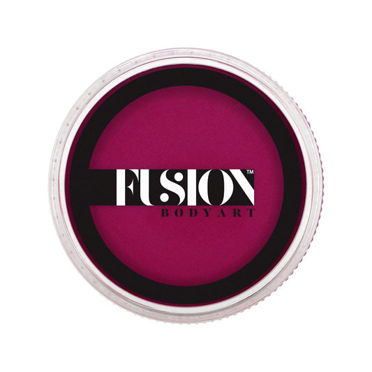 A round container of Infinity Faces Face Paint & Body Paint aqua Fusion - Prime Magic Magenta (32g) with a transparent lid revealing dark maroon color inside. The lid displays the Fusion Body Art logo in bold black and white.