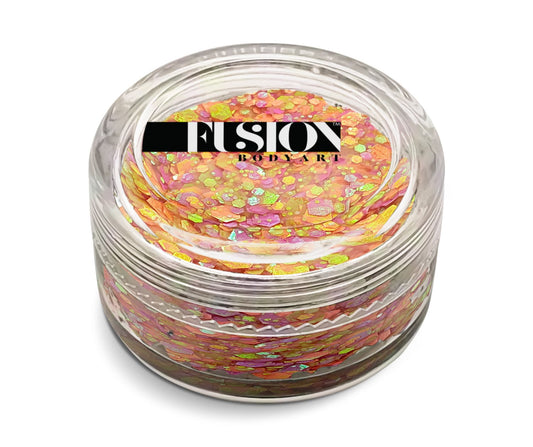 A clear glass jar of Infinity Faces Glitter Cream Fusion - Fairy Sprinkles UV (10g), filled with iridescent pink and orange glitter flakes, topped with a black and white label.