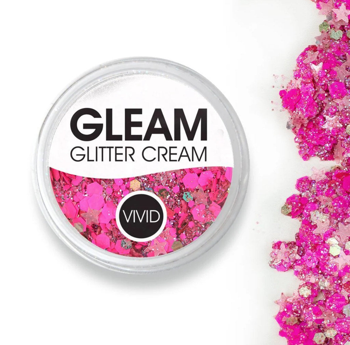 A round container labeled Infinity Faces Glitter Cream Gleam - Watermelon (10g) filled with chunky pink and silver glitter, with some glitter spilled beside it on a white surface.
