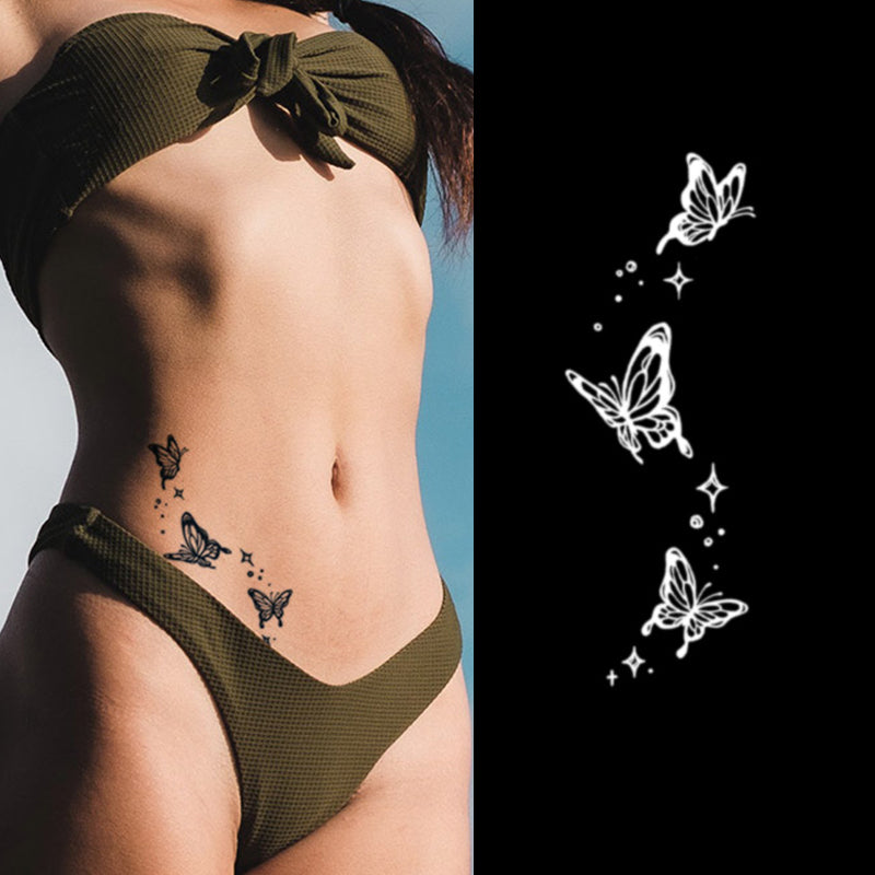 A person wearing an olive green swimsuit showcases their natural butterfly tattoos on the hip. Beside them, the Temporary Herbal Tattoo - Molting into Butterfly by Infinityfaces, features three white butterflies with sparkles on a black background, capturing ethereal elegance.