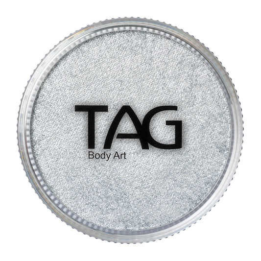 A round container of Infinity Faces Face Paint & Body Paint Aqua Tag - Pearl Silver (32g), viewed from above. The clear lid shows the brand name Infinity Faces in bold black letters over the shimmery silver paint.