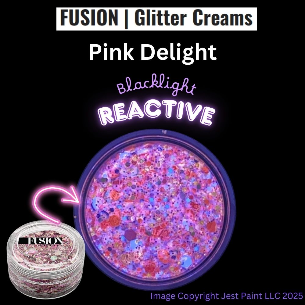 A round container of Infinity Faces Glitter Cream Fusion - Pink Delight UV (10g) displays pink, purple, and silver glitter. Text notes it is blacklight reactive. © Jest Paint LLC 2025.