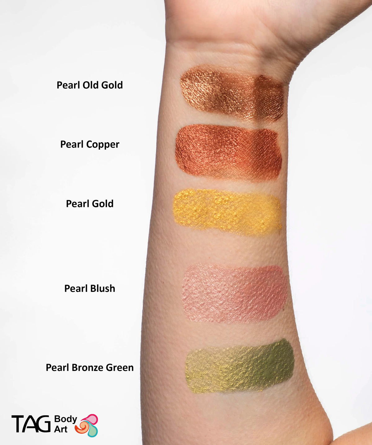Five swatches of shimmering TAG Face & Body Paint - Pearl Bronze Green (32g) in metallic gold, copper, bronze, blush, and green shades displayed on a forearm.
