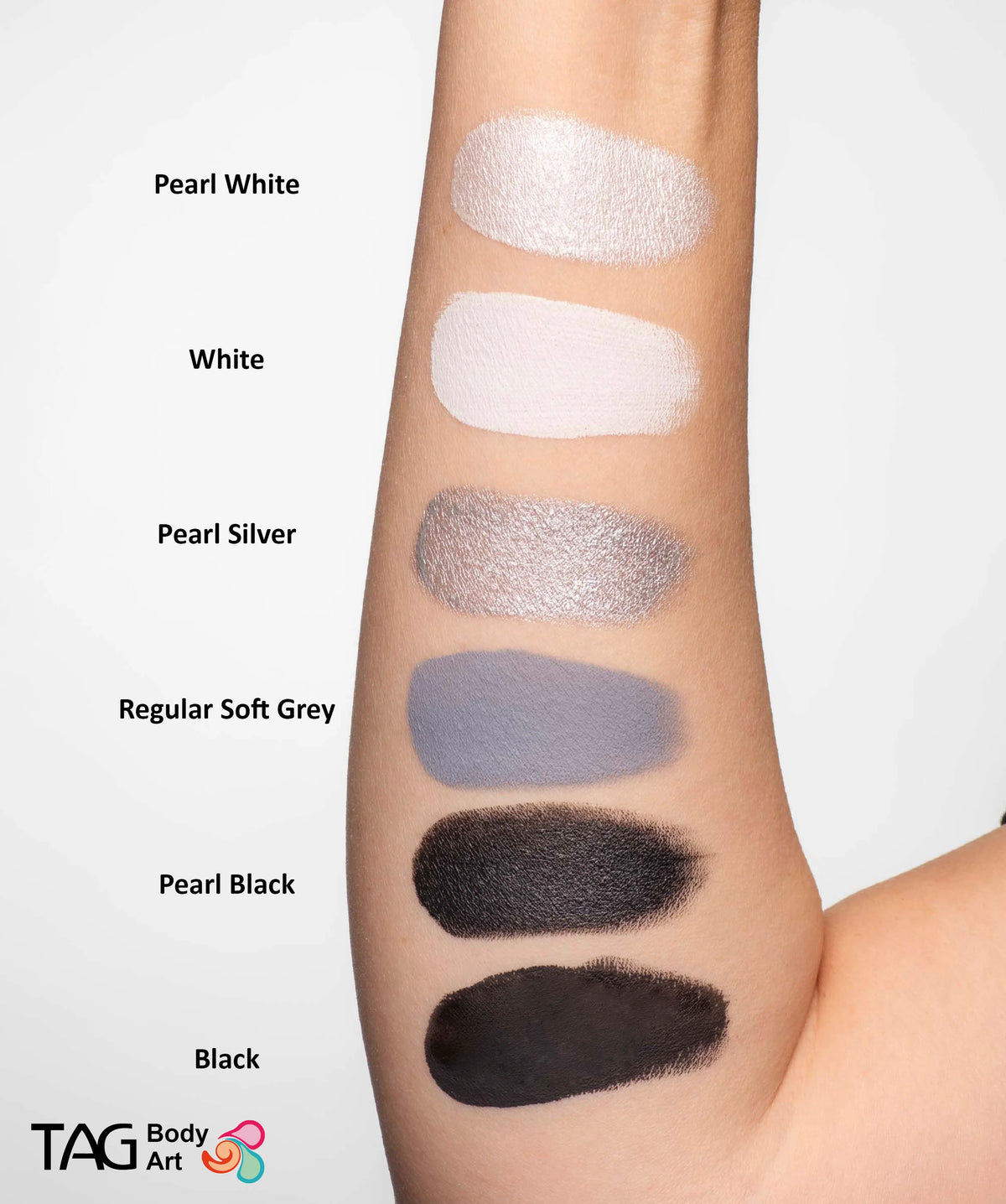 Six swatches of TAG Face & Body Paint - Pearl White (32g) and other shades on an arm, labeled from top to bottom: Pearl White, White, Pearl Silver, Regular Soft Grey, Pearl Black, and Black.