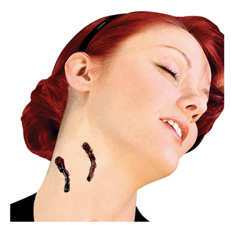 A red-haired woman tilts her head back, revealing two Infinityfaces Woochie Mehron Vampire Bite prosthetics on her neck, and smiles slightly. The image conveys a Halloween or costume theme.