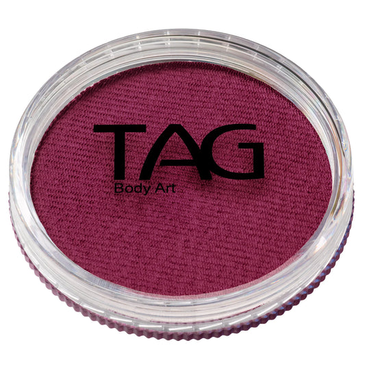 A circular container of deep magenta TAG Face & Body Paint - Watermelon (32g) water-activated face paint.