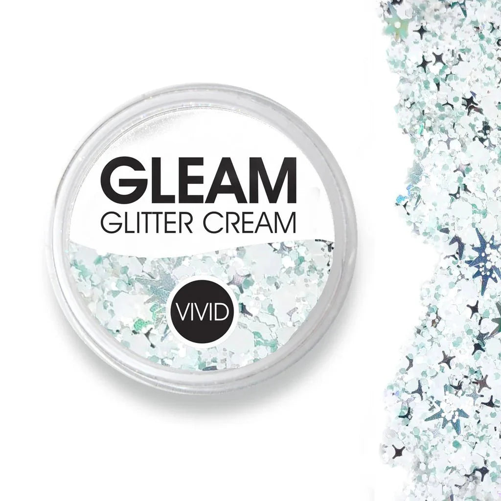A round container of Infinity Faces Glitter Cream Gleam - Avalanche (10g) NEW with a clear lid reveals iridescent white and silver glitter, shown next to a close-up of the loose flakes.